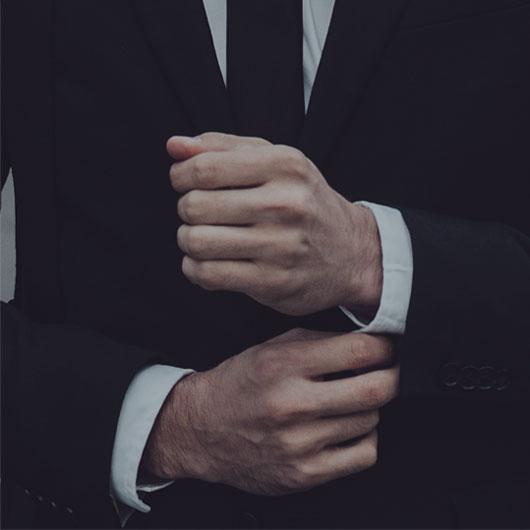 man buttoning shirt cuffs Macdonald & Sager LLP employment law
