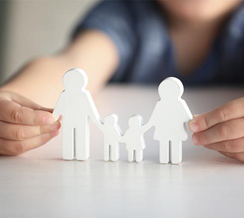 child holden wooden cut out of a family